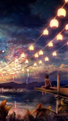 a person sitting on a dock watching fireworks