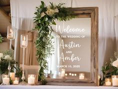 a sign that says welcome to the wedding of aussie and amber on top of a mantle with candles