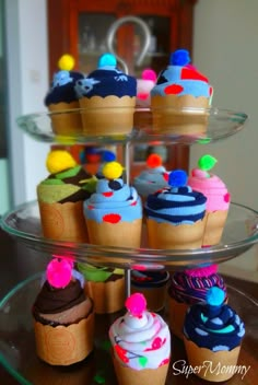 several cupcakes are displayed on three tiered plates