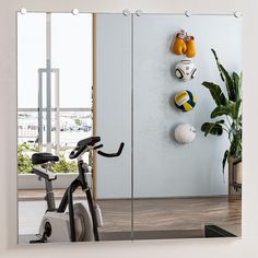 there is a mirror that has balls on the wall and a bike in front of it