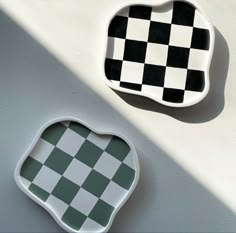 two black and white checkered plates sitting next to each other