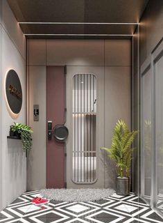 the interior of a modern bathroom with black and white tile flooring, potted plant and mirror on the wall