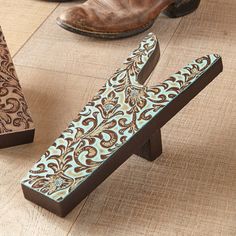 three decorative wooden letters sitting on top of a wood floor next to boots and purses