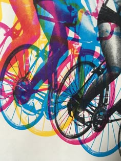 a person riding a bike in front of a colorful background