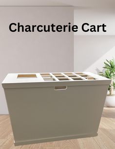 a large white box sitting on top of a wooden floor next to a potted plant