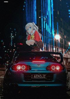 the back end of a car parked in front of a tall building at night with anime characters on it