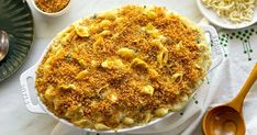 a casserole dish with cheese and bread crumbs in it on a table