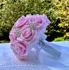 a bridal bouquet with pink roses and diaper