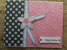 a pink and black card with a bow on it