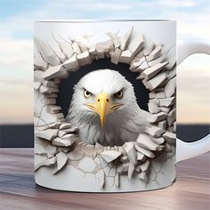 an eagle looking through a hole in a coffee mug that has been made to look like it is breaking apart