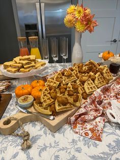 a table topped with lots of waffles and oranges