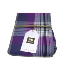 a purple and blue plaid fabric with a tag on it that says ppp durham