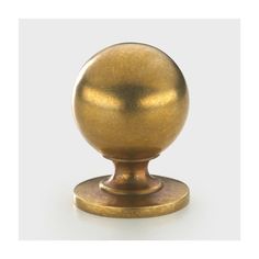 an antique brass ball on a stand