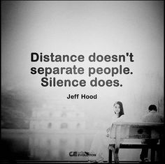 a man and woman sitting on a bench in front of a large poster with the words distance doesn't separate people silentce does