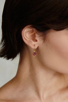 An elegant way to wear your birthstone. Faceted ruby crystals sparkle in these timeless gold hoop earrings. 18k gold plated sterling silver. 1" drop. Handmade in Vietnam. Ruby Hoop Earrings, Yellow Gold Huggie Earrings With Birthstone For Gift, Elegant Gold Huggie Earrings With Birthstone, Gold Sterling Silver Huggie Earrings With Birthstone, Gold Huggie Earrings With Birthstone For Fine Jewelry, Gold Birthstone Huggie Earrings Fine Jewelry, Gold Huggie Earrings With Birthstone, Gold Hoop Earrings With Birthstone, Gold Hoop Earrings With Birthstone - Fine Jewelry