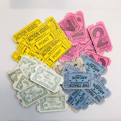 several different colored tickets sitting on top of a white table next to eachother