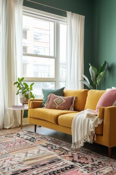 a living room with green walls and a yellow couch in front of a large window