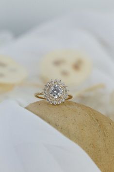 a diamond ring sitting on top of a pillow