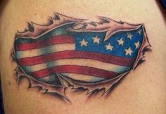 an american flag tattoo on the back of a woman's shoulder