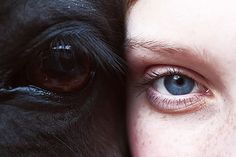 a close up of a person's face next to a dog with blue eyes