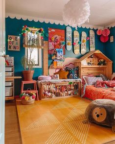 a child's bedroom with blue walls and wooden flooring, decorated in bright colors