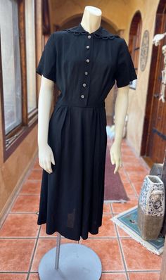 Simple and sweet 40s black crepe dress, by Carole King. Adorned with original flower buttons, Crown side zipper, beautiful lapel detail, and sewn in shoulder pads. Designed for a junior frame, this dress is petite and in beautiful condition for its age, just missing her original belt and some minor white marks on the collar, last photo. Measurements taken while lying flat, doubled when necessary: Bust: 36" Waist: 26" Hips: 36" Sleeve Length: 8.5" Length: 45.5" MANNEQUIN MEASUREMENTS: Bust: 33"  Waist: 23" Hips: 34.25" Black Crepe Dress, Carole King, Missing Her, White Mark, Crepe Dress, Dress Clothes For Women, Shoulder Pads, Favorite Outfit, Dress Outfits