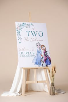 an easel with two princesses on it