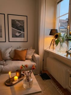 a living room filled with lots of furniture next to a large window covered in sunflowers