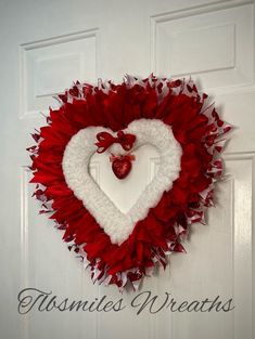 a heart shaped wreath hanging on the front door