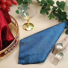 a blue napkin and silverware on a table