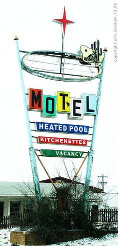 the motel sign has been knocked over and is now on display in front of its owner's house