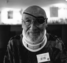 an old man with glasses and a collar around his neck