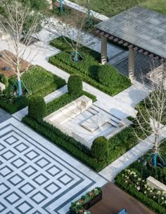 an aerial view of a courtyard with trees and bushes