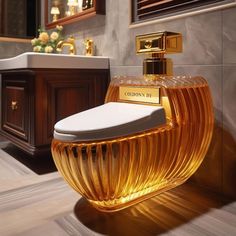 a bathroom with a toilet, sink and vanity in the background that has gold accents on it