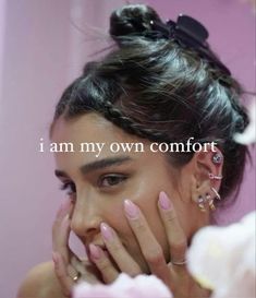 a woman with pink nail polish holding her hand to her face and the words i am my own comfort