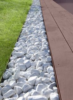 two rows of rocks are lined up along the edge of a walkway