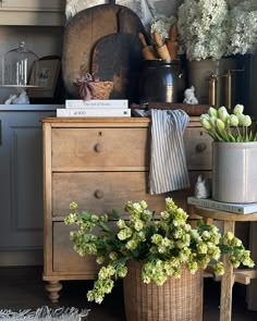 an old dresser with flowers and other items on it