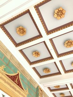 the ceiling is decorated with gold and green designs