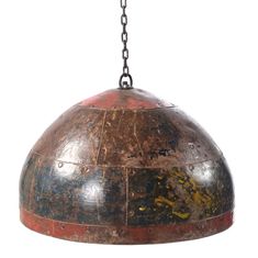 an old metal dome light hanging from a chain