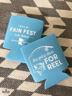 two blue coasters sitting on top of a black and white checkered floor next to each other