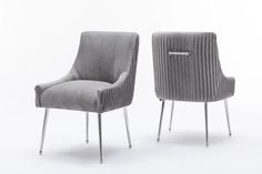 two gray chairs sitting next to each other on top of a white floor with metal legs