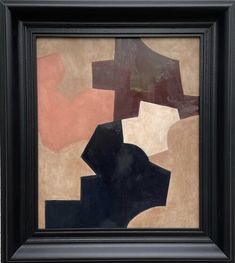 an abstract painting in black frame with brown and pink shapes on the wall behind it