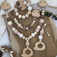 a wooden bead necklace and earring set sitting on top of a piece of wood