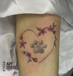 a heart shaped tattoo with flowers and a dog's paw in the shape of a heart