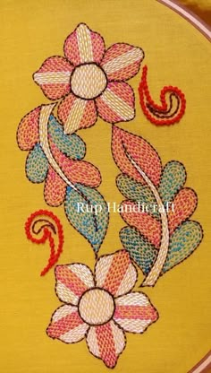 an embroidered flower on a yellow background