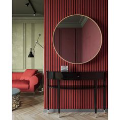 a living room with red and black striped walls, a round mirror on the wall