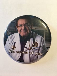 a button with the words i'm proud of you written on it and a doctor in white lab coat