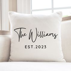 a white pillow that says the williamss on it