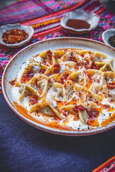 a plate full of pasta with sauce and seasonings