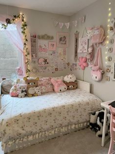 a child's bedroom decorated in pink and white with teddy bears on the wall